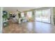Spacious living room offering an open floor plan, tile flooring, ample lighting and backyard access at 43561 W Snow Dr, Maricopa, AZ 85138