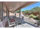 Covered patio with outdoor seating area and view of the landscaped backyard at 43561 W Snow Dr, Maricopa, AZ 85138