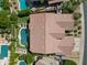 An aerial shot of a home with a tile roof, a private pool, lush landscaping, and neighboring properties in a residential area at 4410 E Robin Ln, Phoenix, AZ 85050