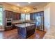 Spacious kitchen featuring dark wood cabinets, granite countertops, and stainless steel appliances at 4410 E Robin Ln, Phoenix, AZ 85050