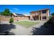 Spacious backyard featuring a rectangular lawn, gravel landscaping, and privacy walls at 44865 W Woody Rd, Maricopa, AZ 85139