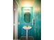 Stylish bathroom featuring turquoise colored walls and a sink at 44865 W Woody Rd, Maricopa, AZ 85139