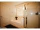 Bright bathroom featuring a tub with flower decorations, a shower, and a white door at 44865 W Woody Rd, Maricopa, AZ 85139