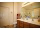 Bathroom featuring a double sink vanity and framed mirror, providing ample space at 44865 W Woody Rd, Maricopa, AZ 85139