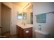 Bathroom with a vanity, toilet, and mirrored cabinets and a towel bar at 44865 W Woody Rd, Maricopa, AZ 85139
