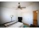 Bedroom with a ceiling fan and a modern style bed and furniture at 44865 W Woody Rd, Maricopa, AZ 85139
