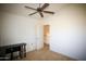 Bedroom featuring a ceiling fan, open door to the hallway and dark furniture at 44865 W Woody Rd, Maricopa, AZ 85139
