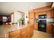 Open kitchen with a view of the stairs, breakfast bar, and modern appliances at 44865 W Woody Rd, Maricopa, AZ 85139