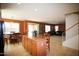 Open concept kitchen overlooking the living area with a breakfast bar and natural light at 44865 W Woody Rd, Maricopa, AZ 85139
