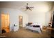 Open main bedroom showcasing ensuite bathroom, neutral carpet, and vaulted ceilings at 44865 W Woody Rd, Maricopa, AZ 85139