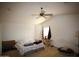 Bright main bedroom featuring a ceiling fan, neutral carpet, and ample natural light at 44865 W Woody Rd, Maricopa, AZ 85139