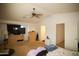 Large main bedroom featuring a ceiling fan, neutral carpeting, and abundant natural light at 44865 W Woody Rd, Maricopa, AZ 85139