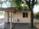 Back house features covered porch, exterior lighting, and small window at 5333 W Dublin Ct, Chandler, AZ 85226