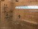Modern shower features tile, glass doors, shower head, and a window at 5333 W Dublin Ct, Chandler, AZ 85226