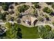 Aerial view of community park featuring desert landscaping, a playground with shade, seating, and manicured grassy area at 5434 E Barwick Dr, Cave Creek, AZ 85331