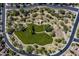 Aerial view of community park with walking path, playground, sports court, and beautiful green space for recreation at 5434 E Barwick Dr, Cave Creek, AZ 85331