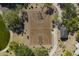 Aerial view showcasing a basketball court with trees, surrounding desert landscaping, and a nearby shade structure at 5434 E Barwick Dr, Cave Creek, AZ 85331