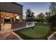 Covered patio with built-in grill, bar, and putting green for outdoor enjoyment at 5434 E Barwick Dr, Cave Creek, AZ 85331