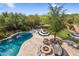 Aerial view of backyard with a pool, spa, fire pit, artificial turf, and lounge areas at 5434 E Barwick Dr, Cave Creek, AZ 85331