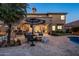 Resort-style backyard boasting a pool, fire pit, and outdoor dining area at 5434 E Barwick Dr, Cave Creek, AZ 85331