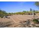 Basketball court surrounded by desert landscaping with shaded seating area, great for recreation at 5434 E Barwick Dr, Cave Creek, AZ 85331