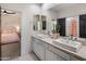 Bathroom features dual sinks, light countertops and a black door at 5434 E Barwick Dr, Cave Creek, AZ 85331