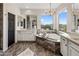 Bright bathroom features a soaking tub, dual vanity, decorative lighting and travertine floors at 5434 E Barwick Dr, Cave Creek, AZ 85331