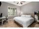Bedroom with a ceiling fan, plantation shutters, and hardwood flooring at 5434 E Barwick Dr, Cave Creek, AZ 85331