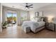 Bright bedroom boasts a private balcony, ceiling fan, and natural light at 5434 E Barwick Dr, Cave Creek, AZ 85331