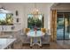 Cozy breakfast nook with a circular table, patterned chairs, and a view of the backyard pool at 5434 E Barwick Dr, Cave Creek, AZ 85331
