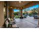 Relaxing covered patio overlooking a lush backyard with a pool and play area at 5434 E Barwick Dr, Cave Creek, AZ 85331