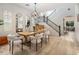 Elegant dining room with modern chandelier, staircase, and designer mirrors at 5434 E Barwick Dr, Cave Creek, AZ 85331