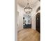 Inviting entryway with hardwood floors, modern chandelier, and an arched doorway to the home gym at 5434 E Barwick Dr, Cave Creek, AZ 85331
