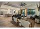 Spacious living room with large windows, modern furnishings, and an open view to the kitchen at 5434 E Barwick Dr, Cave Creek, AZ 85331