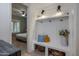 Mudroom area with coat hooks, storage, and view into the bedroom at 5434 E Barwick Dr, Cave Creek, AZ 85331