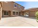 Large backyard area with concrete paving and garage featuring terracotta tiled roof at 5707 N Kristi Ln, Litchfield Park, AZ 85340