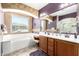 Inviting bathroom offers a soaking tub, vanity, double sinks, and plenty of natural light at 5707 N Kristi Ln, Litchfield Park, AZ 85340