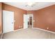 An unfurnished bedroom showcasing an adjoining doorway, neutral carpet, and painted walls at 5707 N Kristi Ln, Litchfield Park, AZ 85340