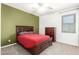 A furnished bedroom featuring neutral carpet, green accent wall, and a ceiling fan at 5707 N Kristi Ln, Litchfield Park, AZ 85340