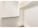 A walk-in closet with white walls and metal clothing rods at 5707 N Kristi Ln, Litchfield Park, AZ 85340