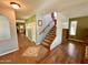 Inviting entryway showcasing the staircase and tiled foyer, leading to living spaces with hardwood floors at 5707 N Kristi Ln, Litchfield Park, AZ 85340