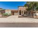 Beautiful two-story home showcasing a terracotta tile roof, arched entry, and mature desert landscaping at 5707 N Kristi Ln, Litchfield Park, AZ 85340