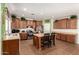 Spacious kitchen offers wood cabinets, an island, stainless appliances, and tile flooring at 5707 N Kristi Ln, Litchfield Park, AZ 85340