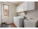 Bright laundry room with cabinets, sink and appliances at 5707 N Kristi Ln, Litchfield Park, AZ 85340