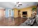 Spacious living room featuring wood floors, ceiling fan, and comfortable seating at 5707 N Kristi Ln, Litchfield Park, AZ 85340
