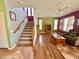 Bright living room featuring a staircase, wood floors, and neutral green and purple colored walls at 5707 N Kristi Ln, Litchfield Park, AZ 85340