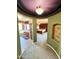 Hallway view into main bedroom and bath featuring custom ceiling paint and carpet flooring at 5707 N Kristi Ln, Litchfield Park, AZ 85340