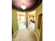 Hallway view into main bedroom and bath featuring custom ceiling paint and carpet flooring at 5707 N Kristi Ln, Litchfield Park, AZ 85340