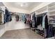 Large walk-in closet features carpet and built-in shelving at 5707 N Kristi Ln, Litchfield Park, AZ 85340