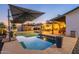 Resort-style backyard featuring a pool, covered seating, and lush greenery, creating a serene retreat at 603 W Keats Ave, Mesa, AZ 85210